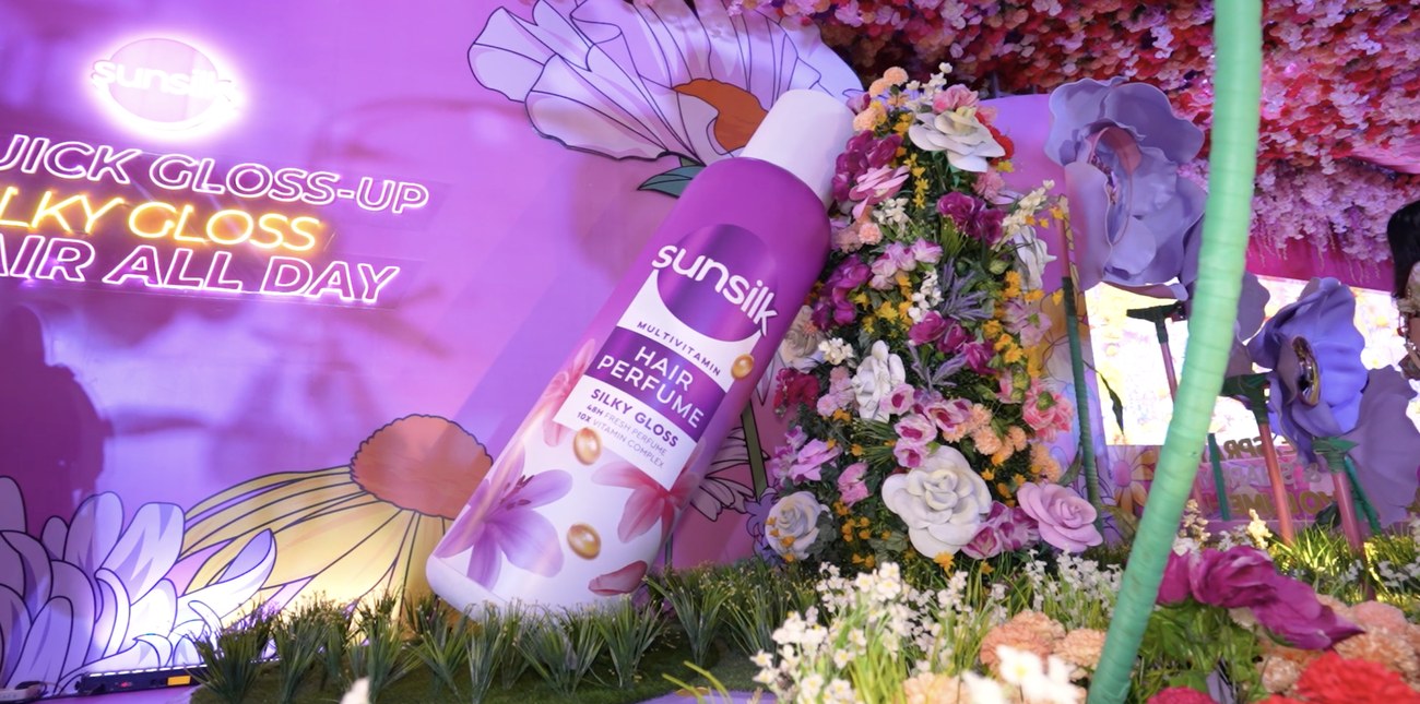 A Sunsilk product display nestled among artificial flowers