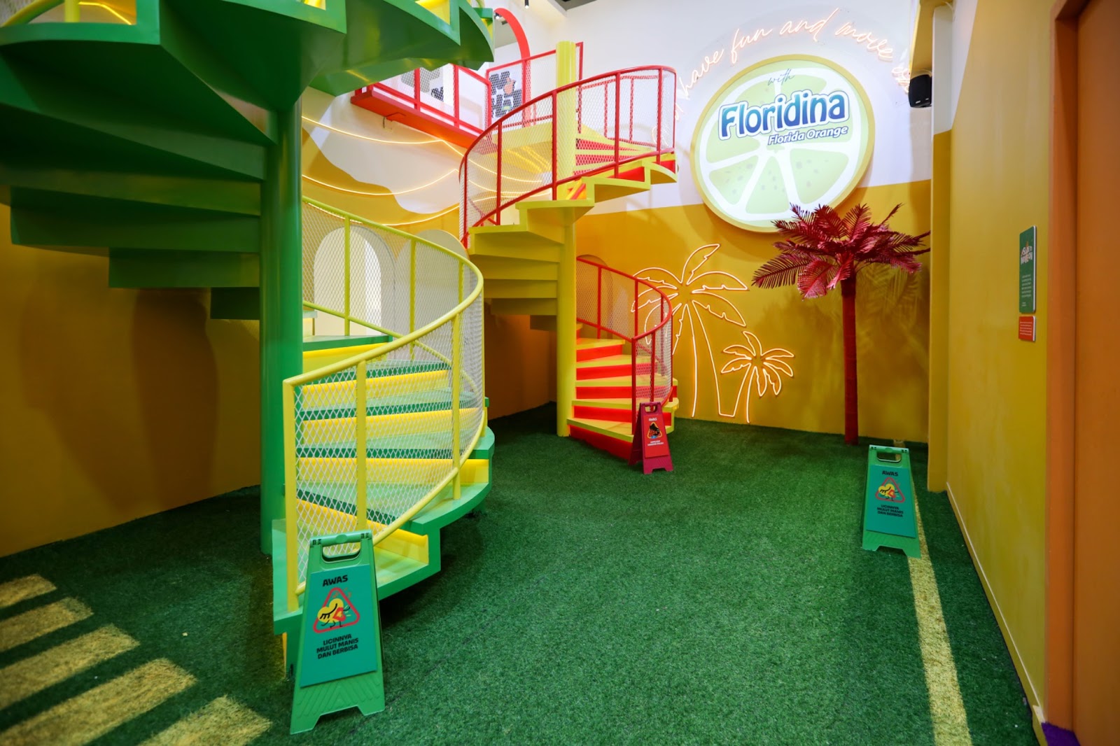 A green-walled room with a rainbow spiral staircase