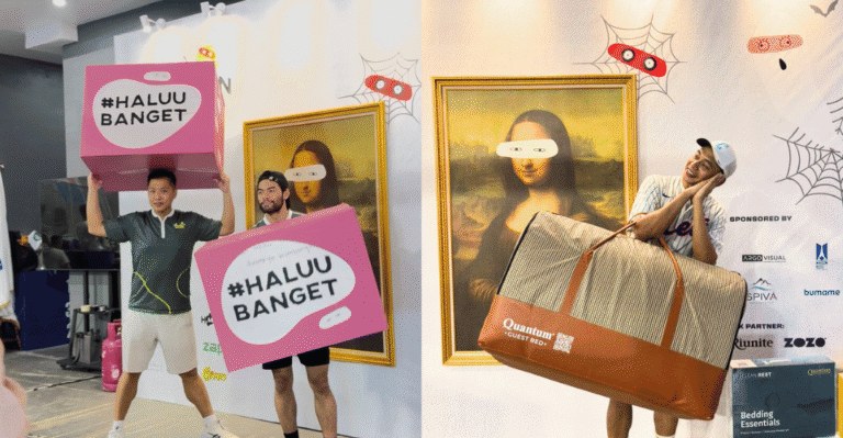 Visitors holding hashtag Haluu Banget signs beside framed artwork