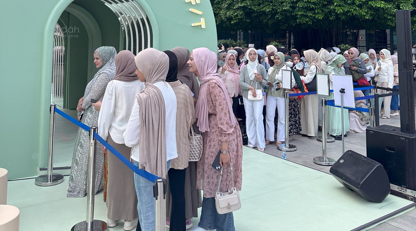 Visitors queuing to enter an arched pop-up entrance