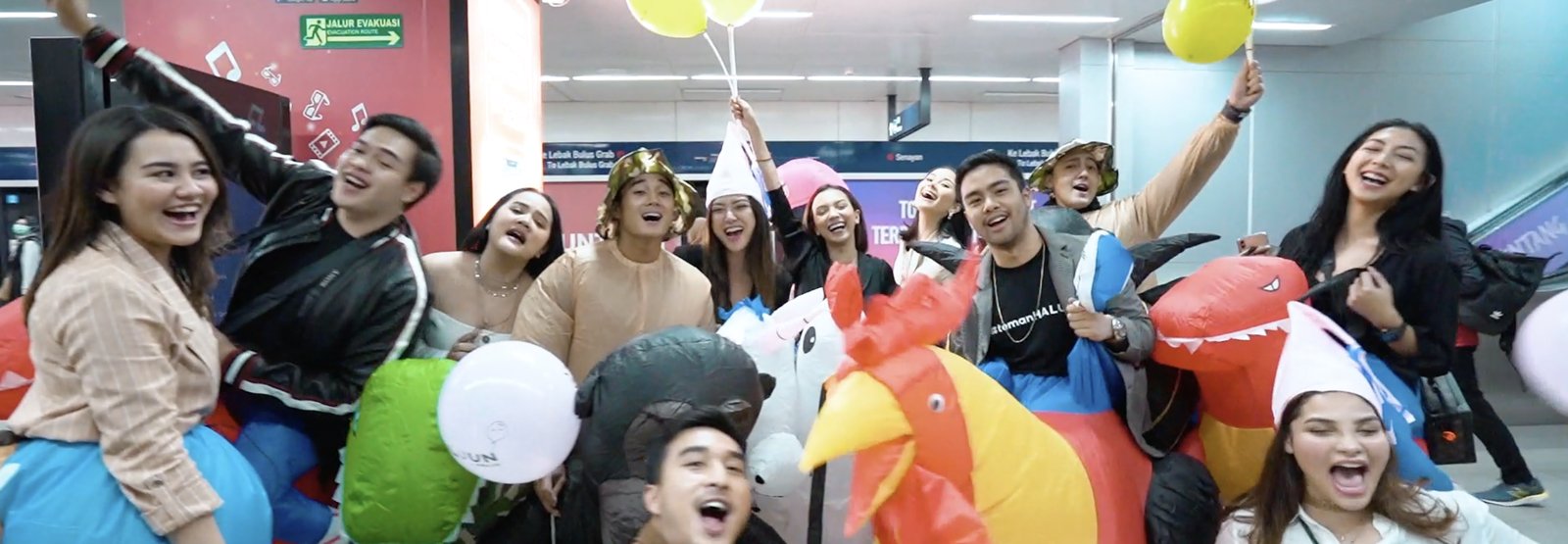 A group celebrating with balloons inside the exhibition