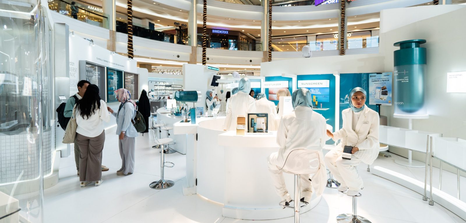 Visitors and staff inside the white Wardah Skinverse Clinic activation in a shopping mall